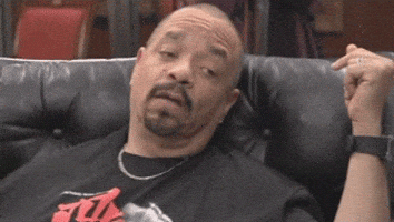 Celebrity gif. Ice-T blinks half asleep on a leather couch, not a thought in his eyes.