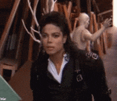 Celebrity gif. Michael Jackson is peering at something with fascination and he steps towards it. He looks closer and scrunches his face in disgust as he steps back slightly, repulsed.