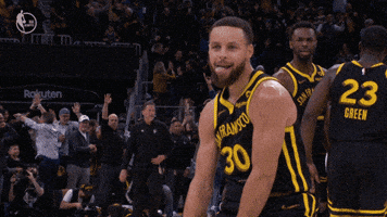 Sports gif. Stephen Curry of the Golden State Warriors crouches down on the court with his arms on his knees and he lets out a roar as he celebrates his score.
