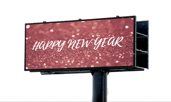 Ad gif. A billboard with a rose gold glitter background with the text, "Happy New Year! Love, The Jodi and Joanna Group."