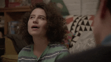 TV gif. Ilana Glazer as Ilana on Broad City looking up and nodding, as if she is slowly understanding something.