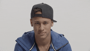 Sports gif. Neymar Jr. wears a backwards cap and a blue jacket while he pumps both fists and gives us a celebratory shout to hype us up.