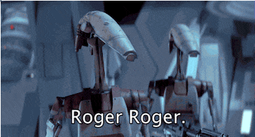 Star Wars gif. Two battle droids looking forward, holding big guns, nod in agreement. Text, "Roger roger."