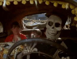 Disney gif. A scene from Halloweentown. Marnie and her sister sit in the backseat of a taxi that’s driven by a skeleton. 