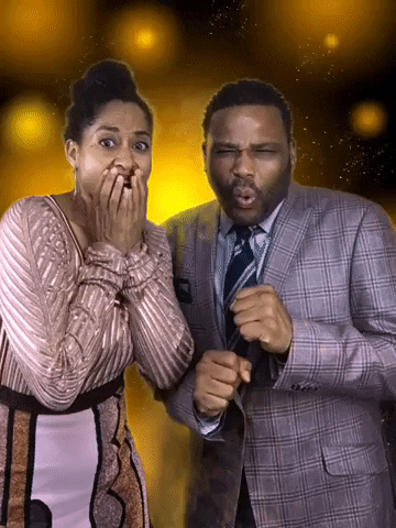 Celebrity gif. Tracee Ellis Ross and Anthony Anderson look at us, grimacing like they’re watching a disaster happen in front of them. Yellow glowing orbs move around in the background.