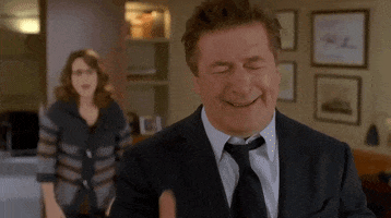 TV gif. Alec Baldwin as Jack in 30 Rock. He sobs and clasps a big hand over his face to hide his cries.