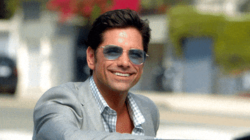 TV gif. John Stamos as Jimmy in Grandfathered grins wide as he nods his head in agreement. 