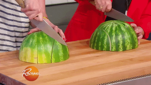 People cutting watermelons into thick slices