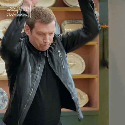 Reality TV gif. The Great British Bake Off judge Benoit Blin throws down both hands, his fingers held wide and says, “boom!”