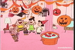 Peanuts gif. Charlie Brown and kids jump for joy at a Halloween party, while Lucy frowns at them.