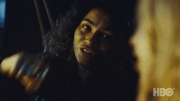 TV gif. Zendaya as Rue on Euphoria smiles and holds out a fist towards another girl next to her. The other girl fist bumps her and Rue pretends her hand explodes.