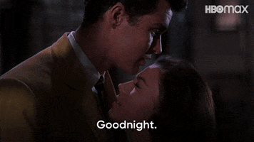Movie gif. Richard Beymer as Tony in West Side Story faces Natalie Wood as Maria, who looks up at him; he tells her "good night," and she says, in Spanish, "buenas noches."