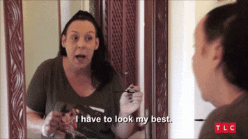 Reality TV gif. Kim Menzies on 90 Day Fiance looks at herself in the mirror. She looks down as she closes her mascara bottle and says, “I have to look my best.”