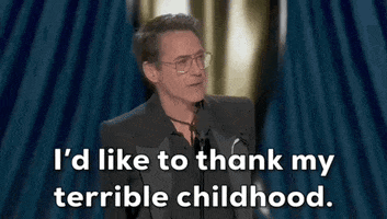 Oscars 2024 gif. Robert Downey Jr wins Best Supporting Actor. He casually stands with his hands behind his back and bluntly says, "I'd like to thank my terrible childhood."