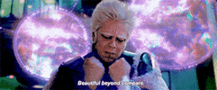 Movie gif. Benicio del Toro as The Collector in Guardians of the Galaxy knocks his fists together and then spreads them open, like an explosion. Text, "Beautiful beyond compare."
