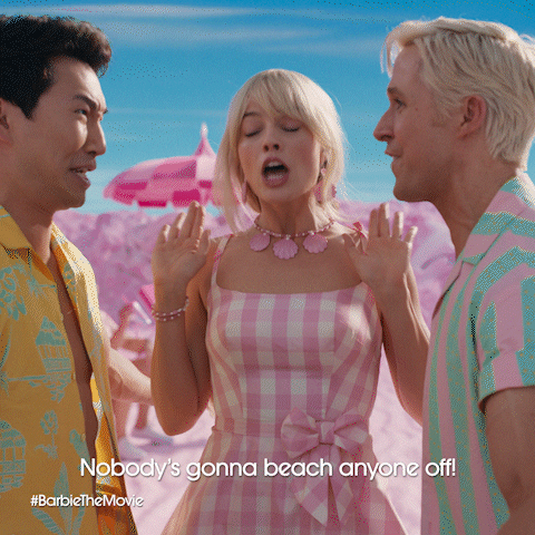 Movie gif. Margot Robbie as Barbie in Barbie holds her hands like she's trying to separate Ryan Gosling as Ken and Simu Liu as Ken. The two Kens are staring each other down in a somewhat aggressive way. Robbie says, "Nobody's gonna beach anyone off!'