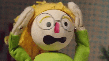 Stop motion gif. A puppet person with blonde hair and glasses has a terrified expression on their face. They hold their head with their hands and shake their head in fear.