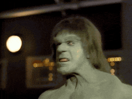 TV gif. Lou Ferrigno as The Incredible Hulk pumps up his arms and grits his teeth in anger.